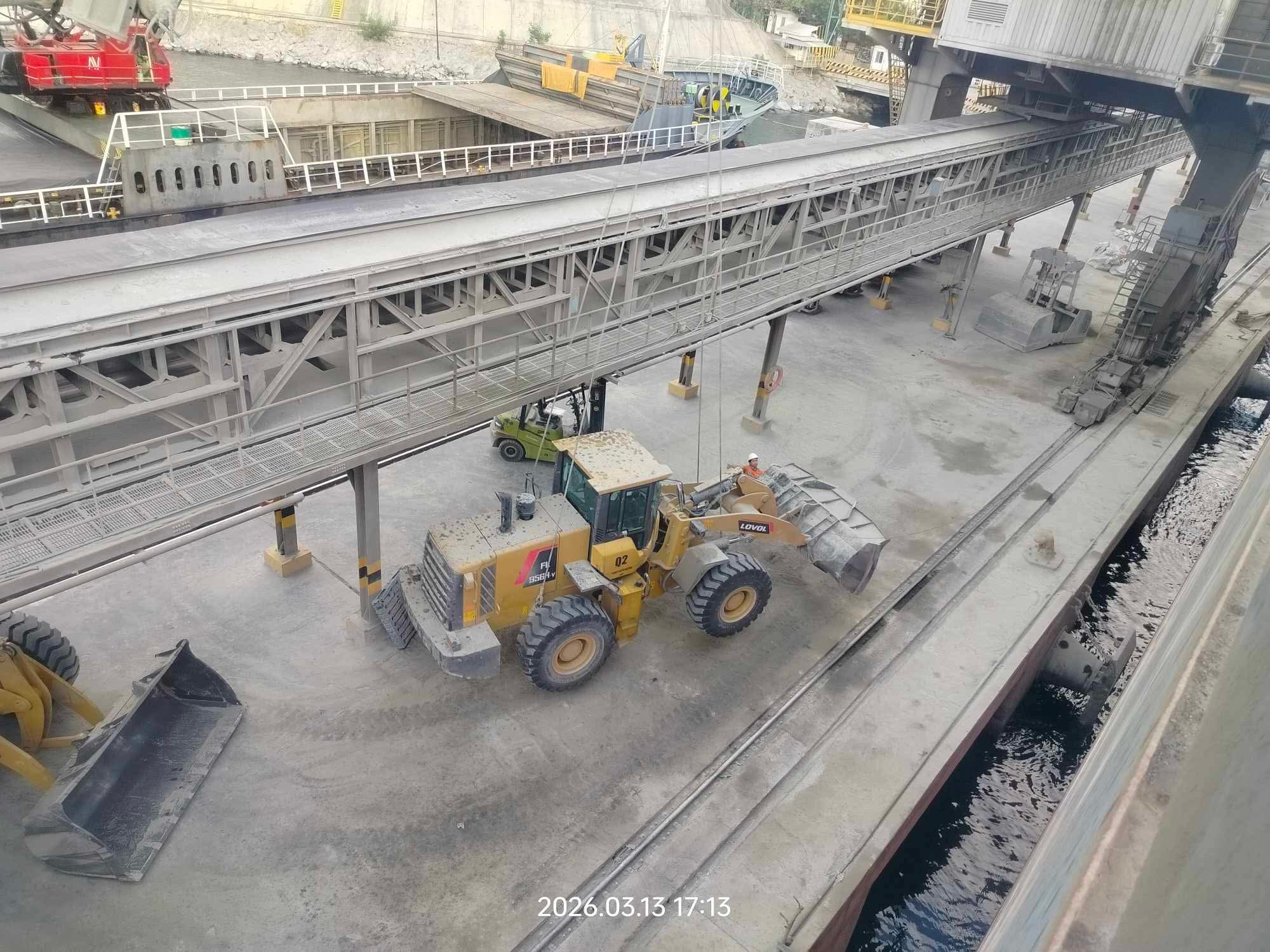 Close-up of a suspended wheel loader during lifting operations