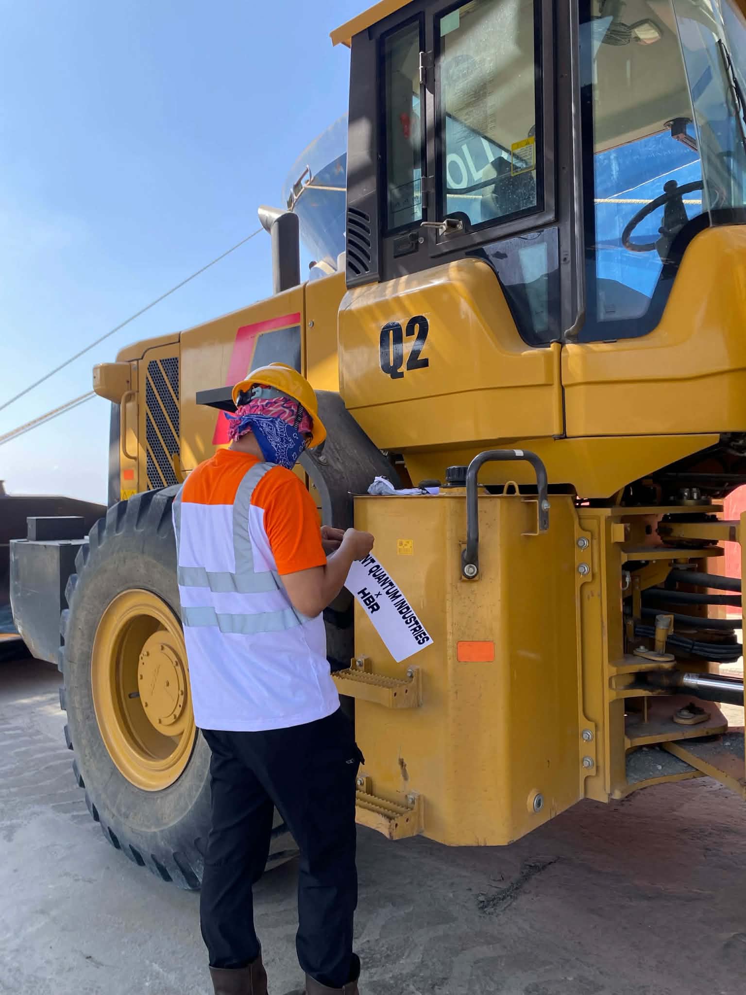 Excavator operating inside a warehouse with bulk material