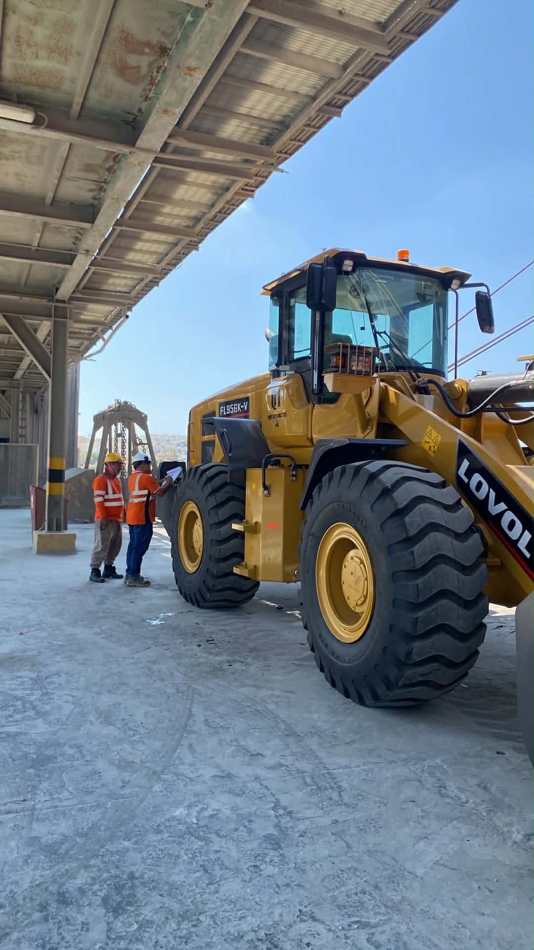 Close-up of a worker checking an HBR wheel loader