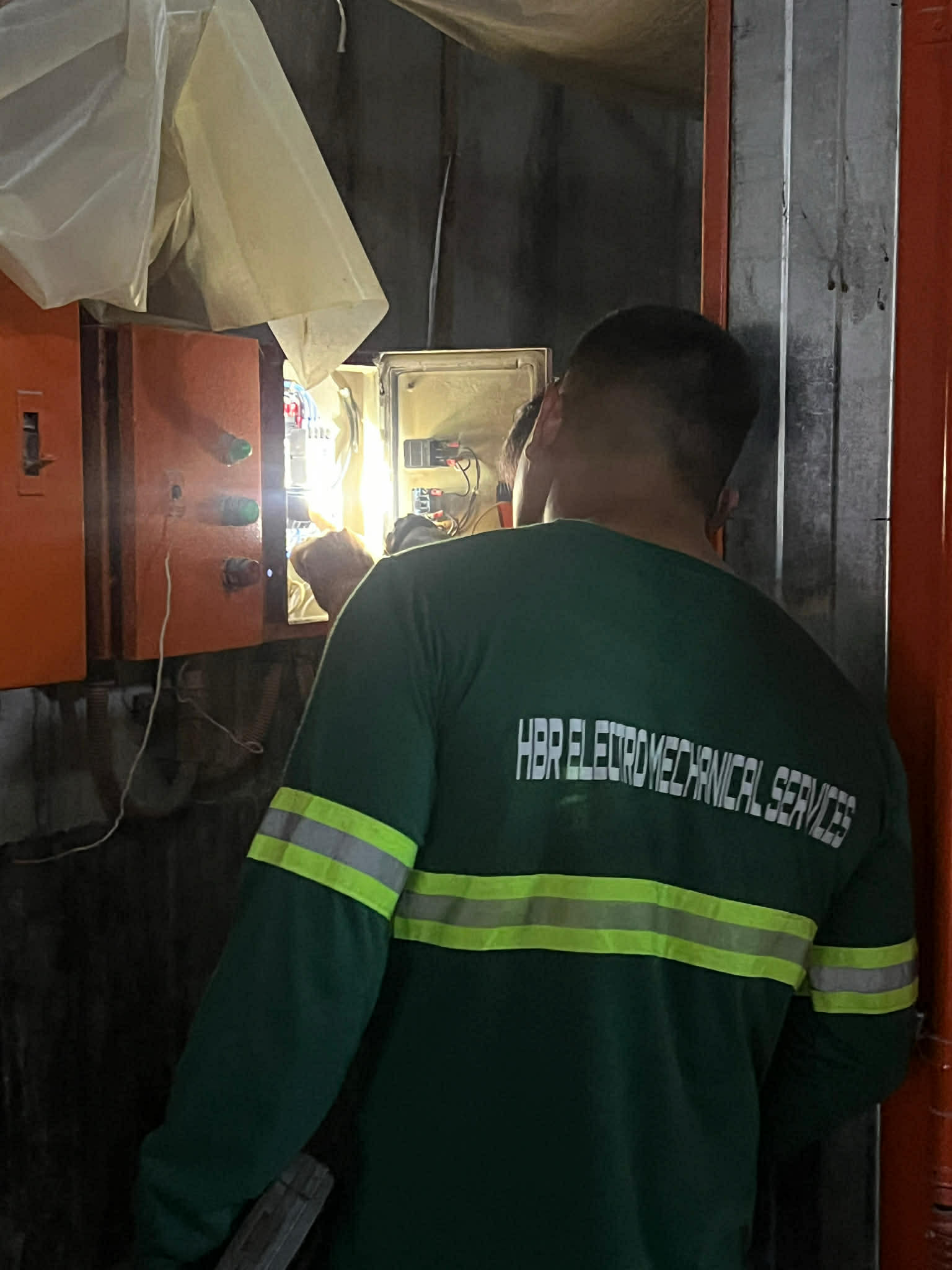 HBR technician working on an electrical control panel